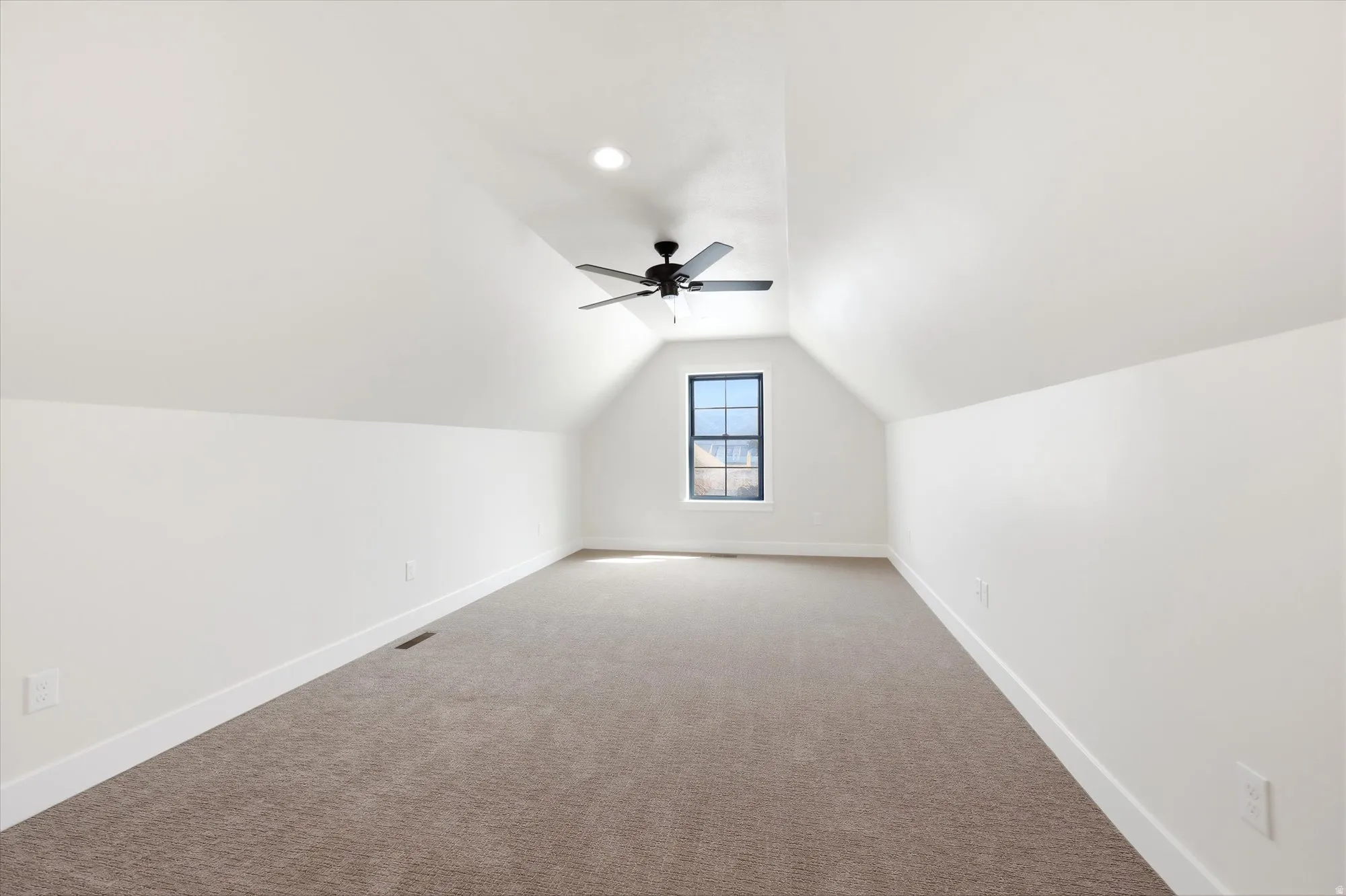 Vaulted ceiling with a ceiling fan, recessed lighting, gabled window, and wall-to-wall carpeting