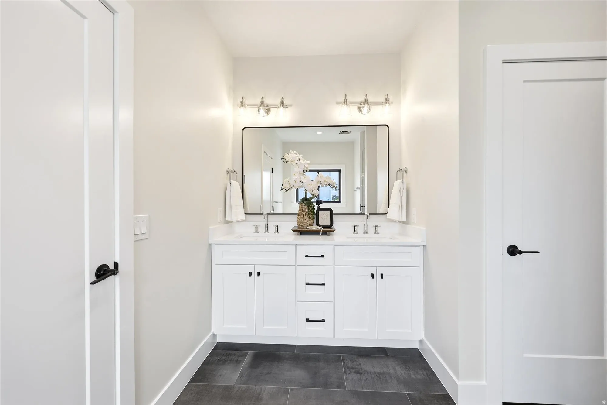 Dual vanity with white cabinetry and integrated sinks