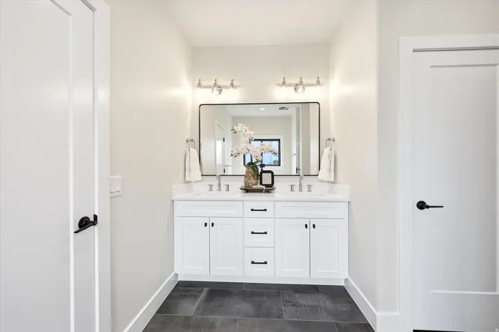 Dual vanity with white cabinetry and integrated sinks