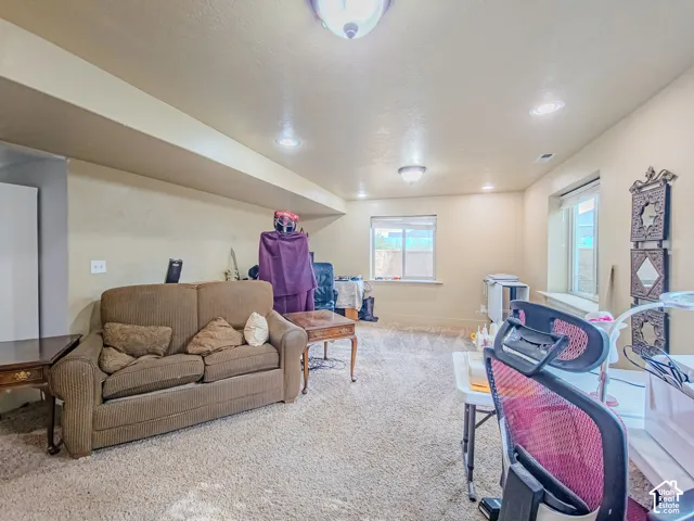 Recessed lighting, wall-to-wall carpeting, and two windows