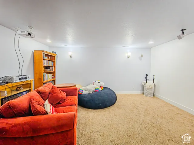 Projector-equipped ceiling, recessed lighting, and wall sconces illuminate the space