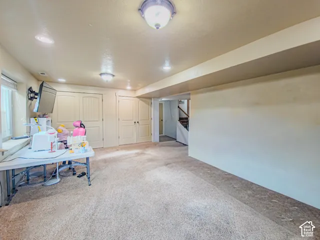 Recessed ceiling lighting, flush mount lighting fixtures, light-toned carpeting, wood-finish doors, and a built-in wall niche