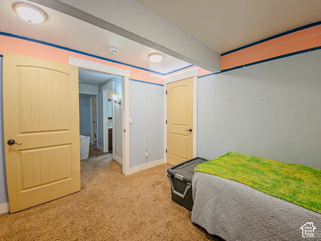 Carpeted flooring, recessed lighting, and a barn-style door