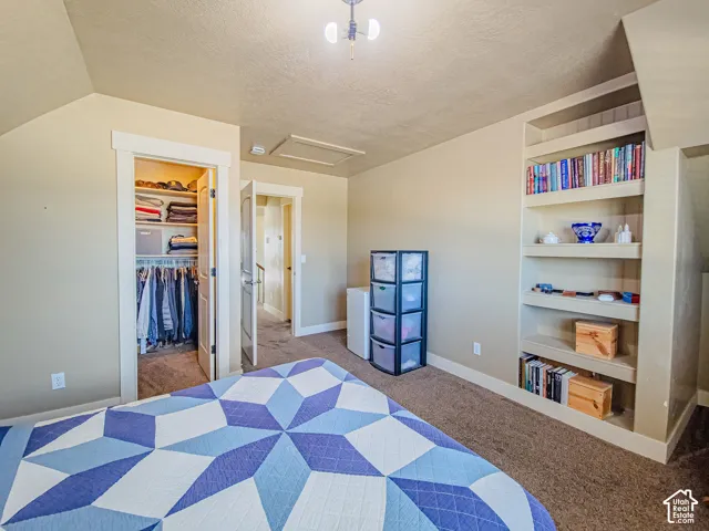 Built-in shelving, plush carpet flooring, and a permanent closet system