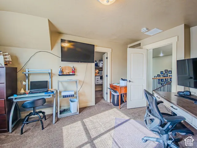 Carpeted flooring, vaulted ceiling, and white paneled doors