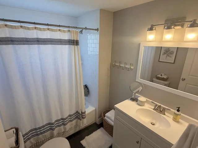 White vanity with an integrated sink and brushed nickel faucet
