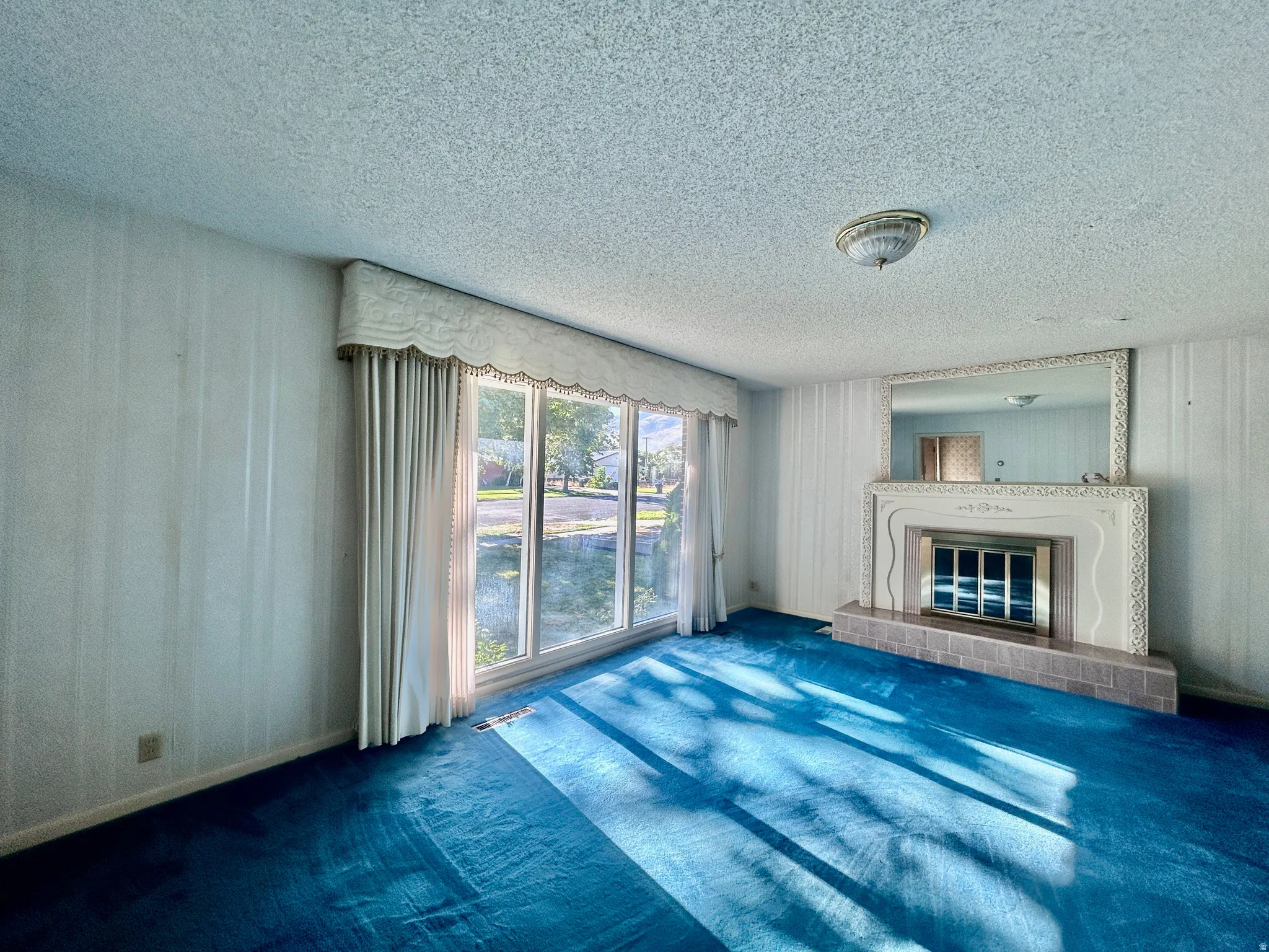 Living room with picture window and beautiful fireplace