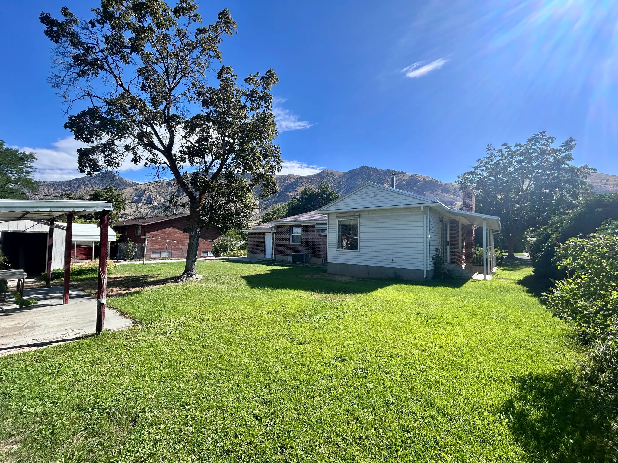Back of the home with family room addition and side entrance to the basement apartment
