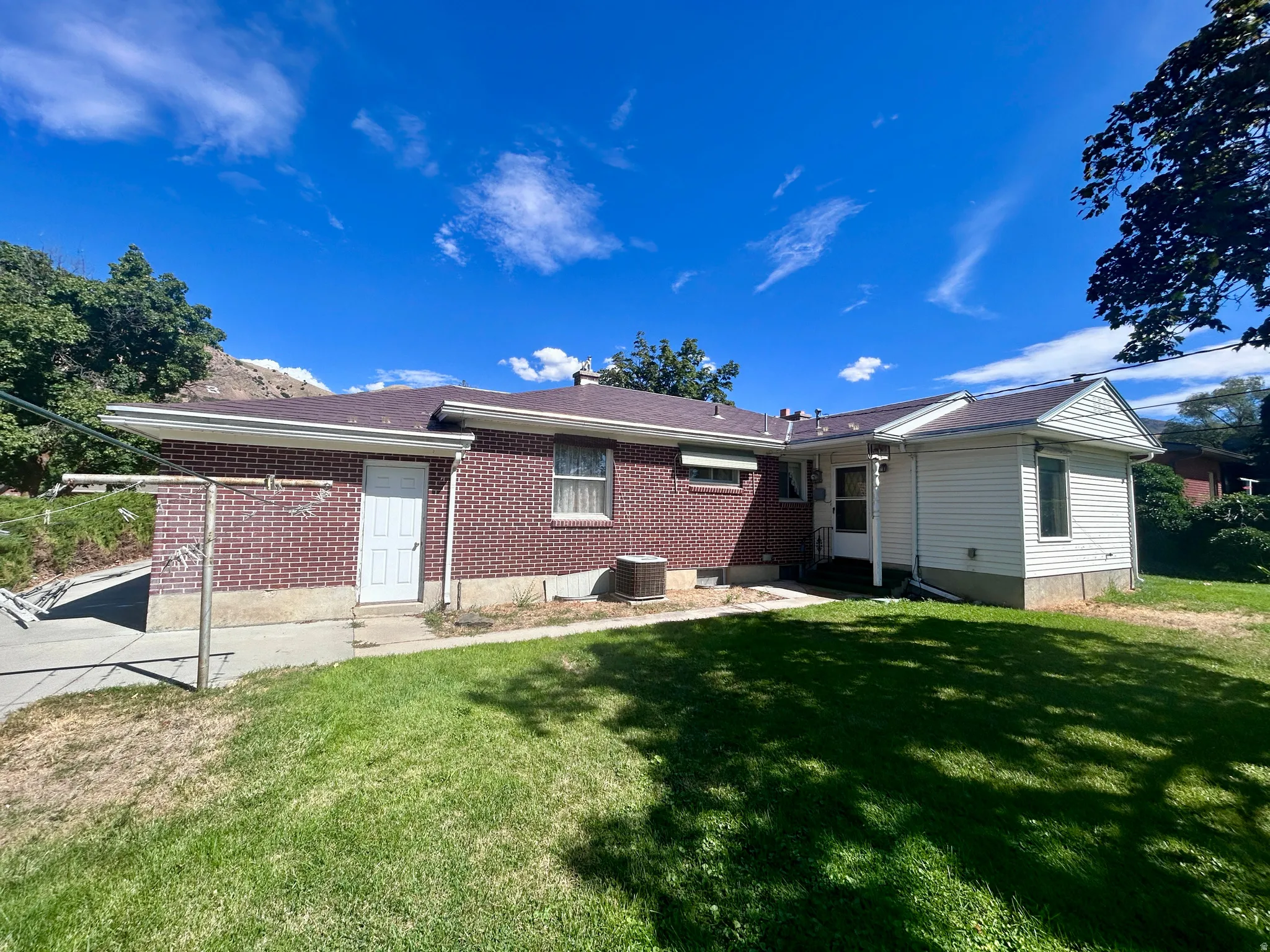 Handy clothesline in the backyard. Entrances to the garage and family room addition.