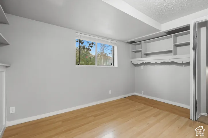 Hardwood-finish flooring, built-in shelving, and a dual-pane window