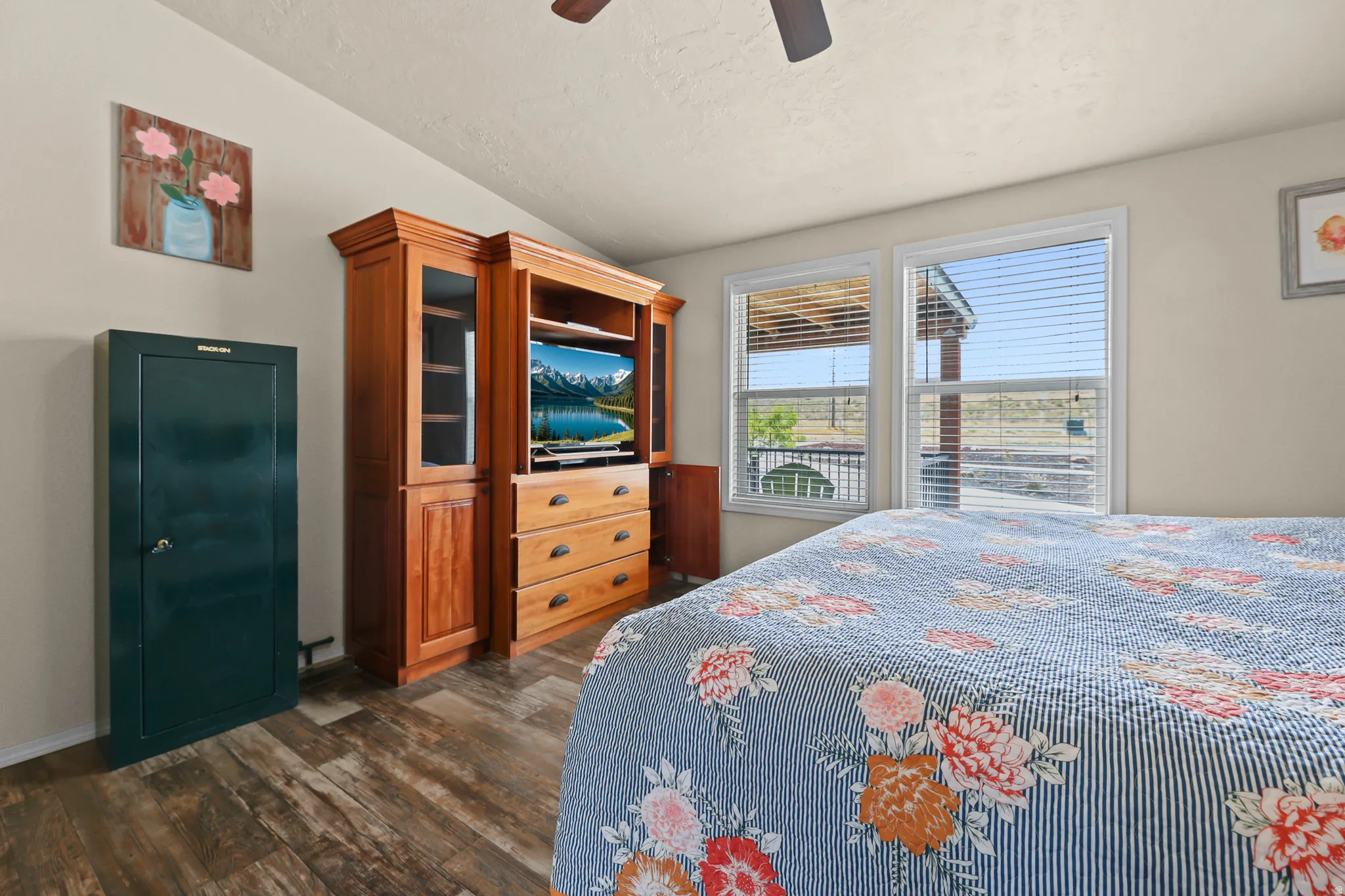 Wood-finish flooring with dual windows providing natural light