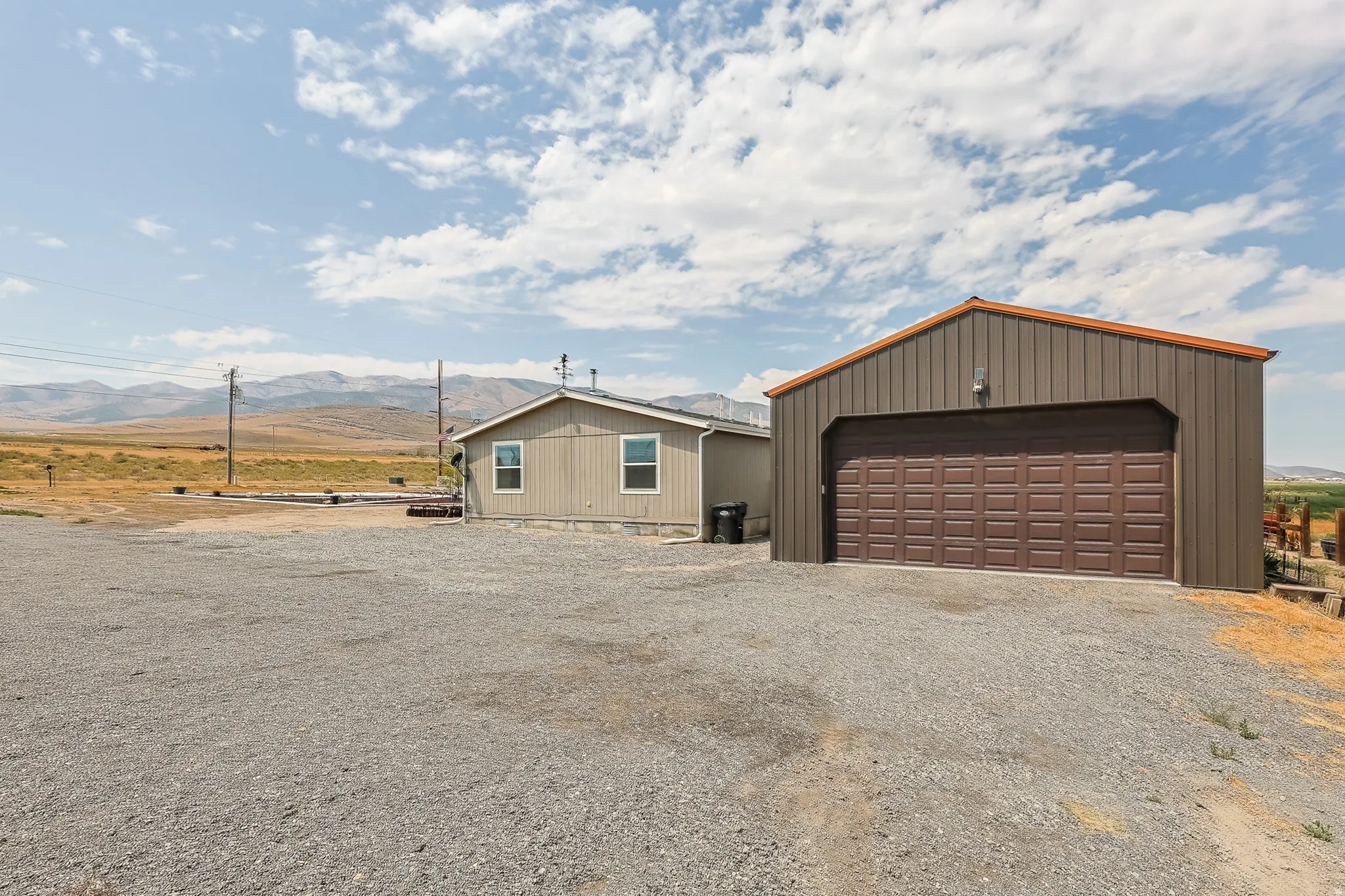 Detached metal outbuilding with a sectional garage door