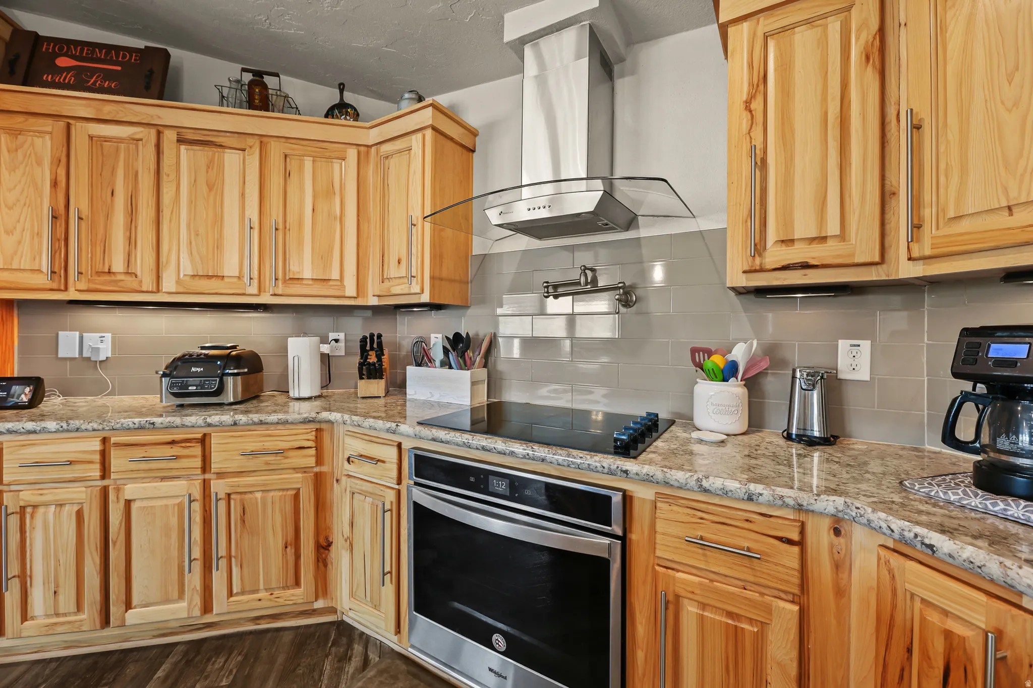 Custom cabinetry with varied wood tones and brushed nickel hardware