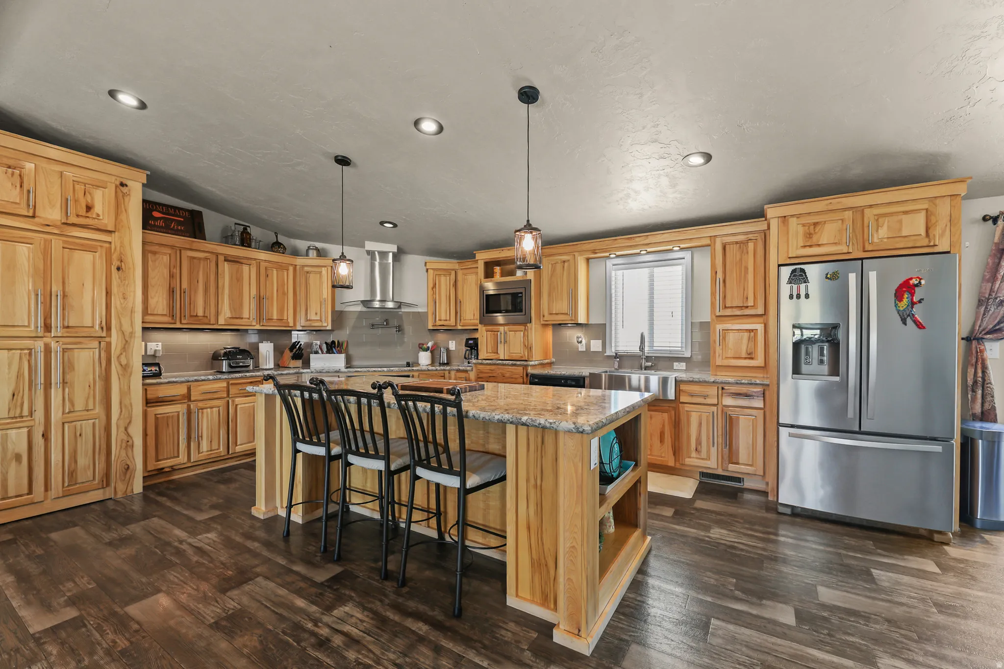 Kitchen featuring wood-finish flooring, recessed lighting, and natural wood cabinetry