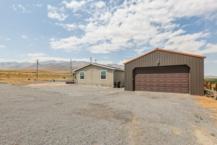 Detached metal outbuilding with a sectional garage door