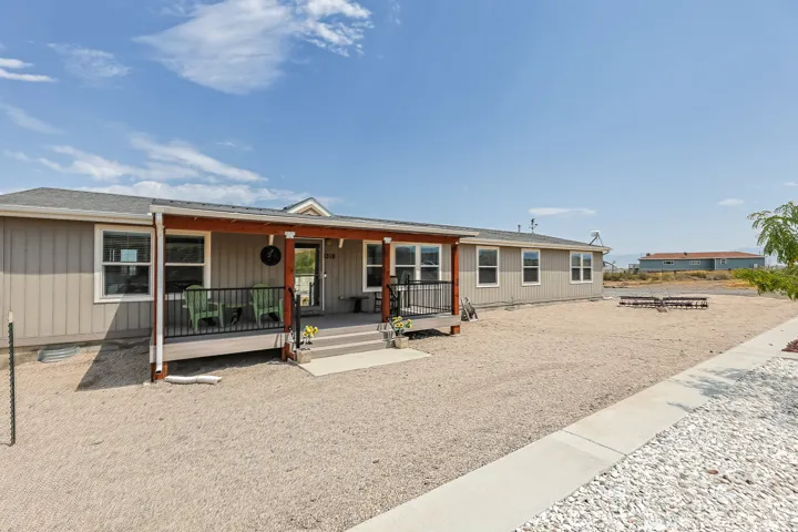 Siding exterior with a covered porch and steps