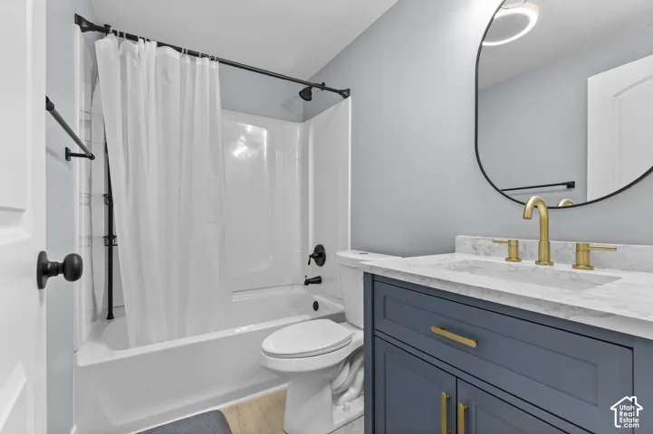 White bathtub and shower combination with matte black fixtures