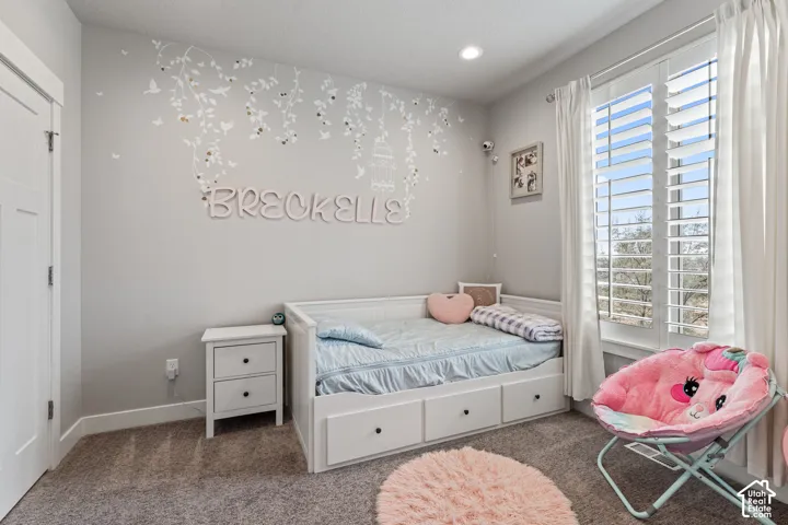 Recessed ceiling lighting, white plantation shutters, and light gray wall paint