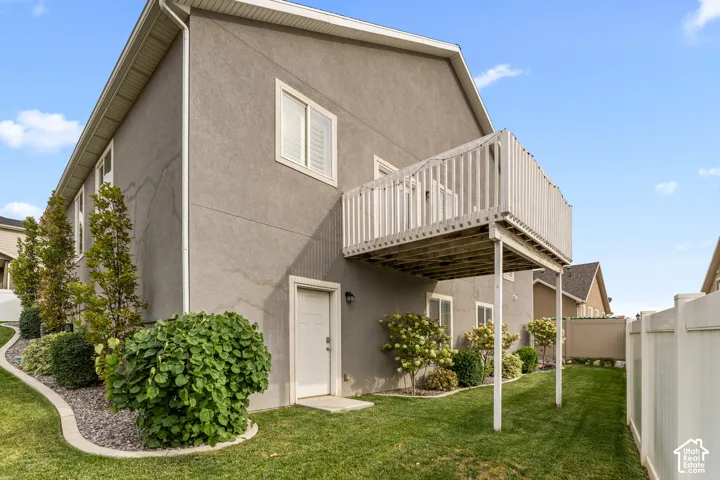 Stucco exterior with white trim windows and a white baluster deck