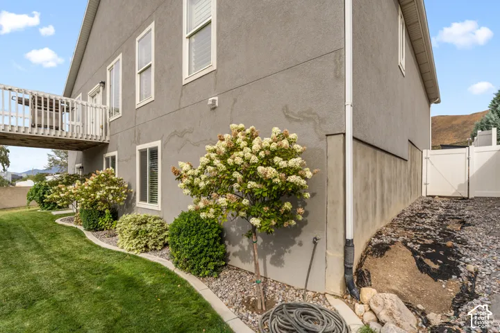 Stucco exterior with multiple windows, leading to a raised balcony
