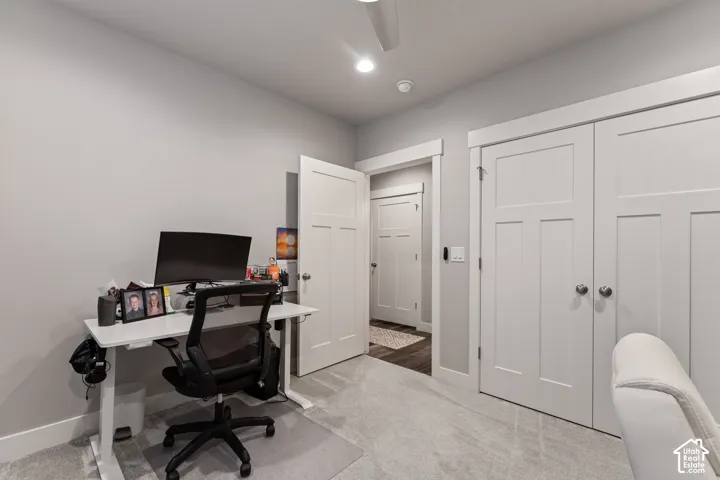 Recessed lighting, ceiling fan, carpeting, white paneled doors, and white trim