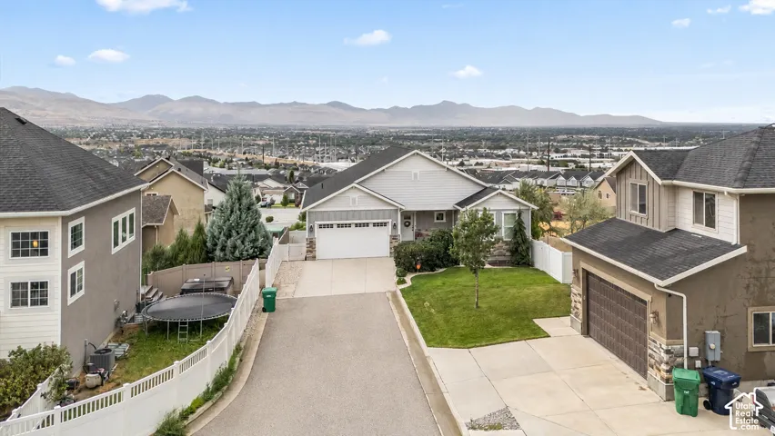Single-story residence featuring a light gray exterior, an attached two-car garage, and a concrete driveway