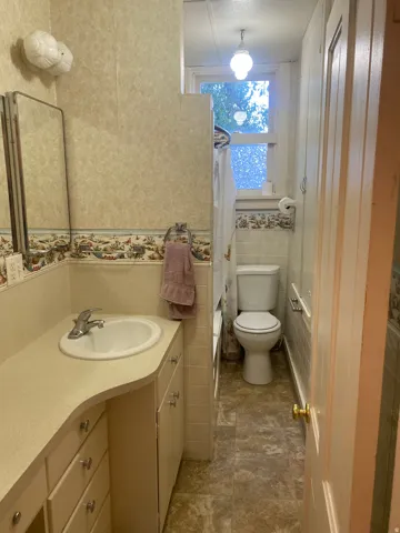 Vanity with integrated sink, chrome faucet, and lower cabinetry
