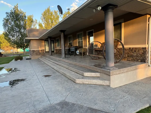 Expansive stamped concrete patio with multiple steps and a ramp