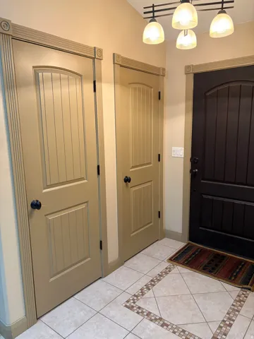 Beige interior doors with decorative trim and black hardware