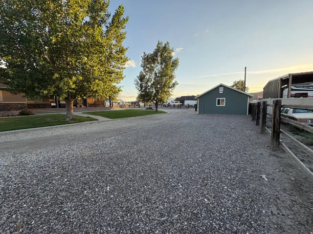 Gravel driveway with a wooden fence