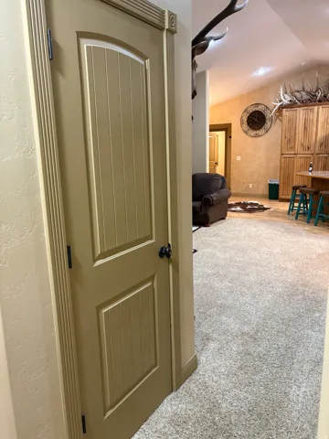 Beadboard interior door with decorative trim and black hardware