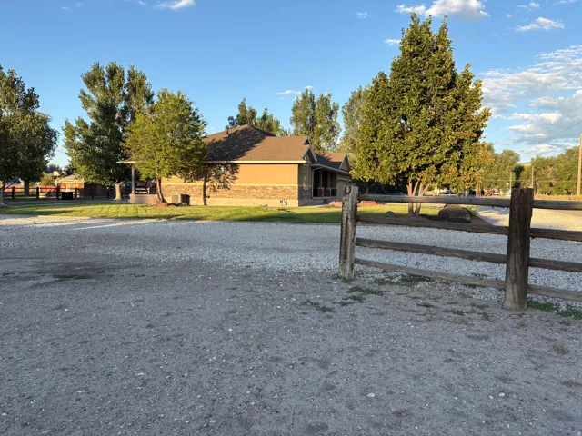 Gravel lot with a three-rail wooden fence