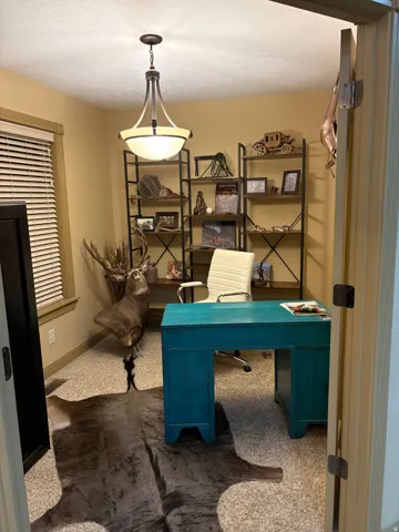 Recessed room with textured wall-to-wall carpeting