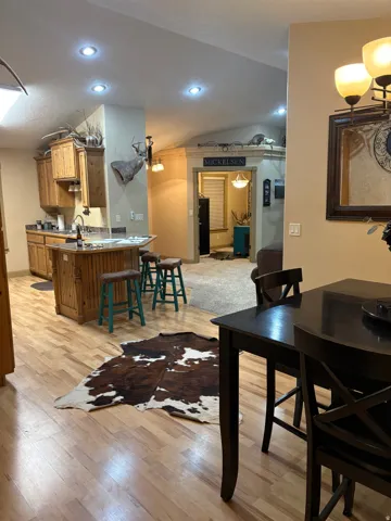 Kitchen with wood cabinetry, recessed lighting, and a breakfast bar
