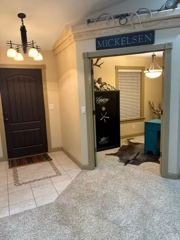 Dark wood entry door with vertical paneling