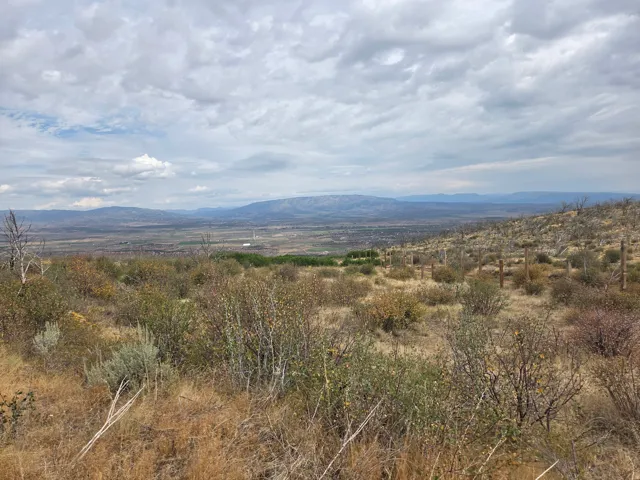 Expansive natural landscape featuring rolling hills, distant mountains, and a beautiful view!