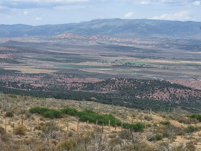 Expansive natural landscape featuring rolling hills, distant mountains, and a beautiful view!