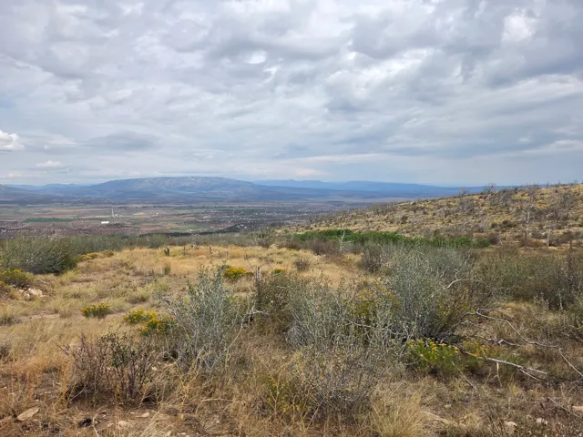Expansive natural landscape featuring rolling hills, distant mountains, and a beautiful view!