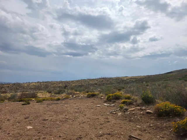 Expansive natural landscape featuring rolling hills, distant mountains, and a beautiful view!