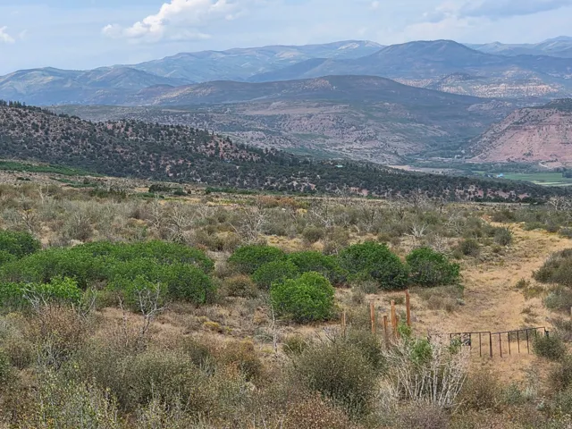 Expansive natural landscape featuring rolling hills, distant mountains, and a beautiful view!