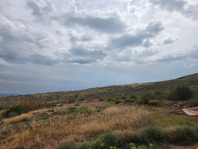 Expansive natural landscape featuring rolling hills, distant mountains, and a beautiful view!