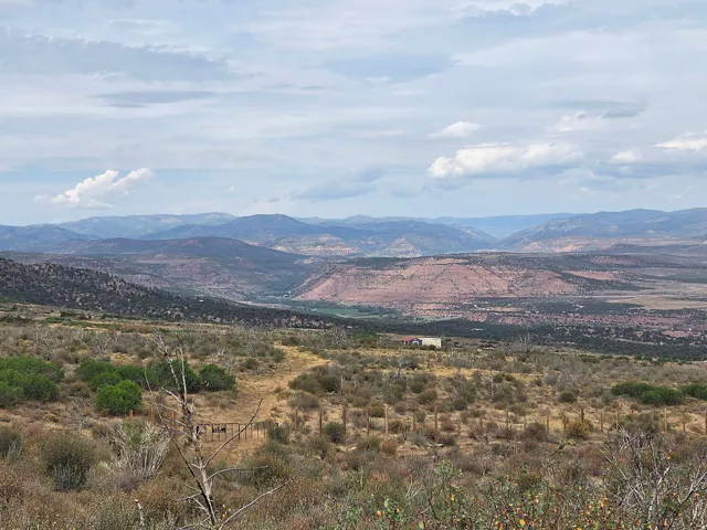 Expansive natural landscape featuring rolling hills, distant mountains, and a beautiful view!