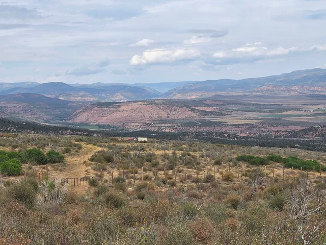 Expansive natural landscape featuring rolling hills, distant mountains, and a beautiful view!