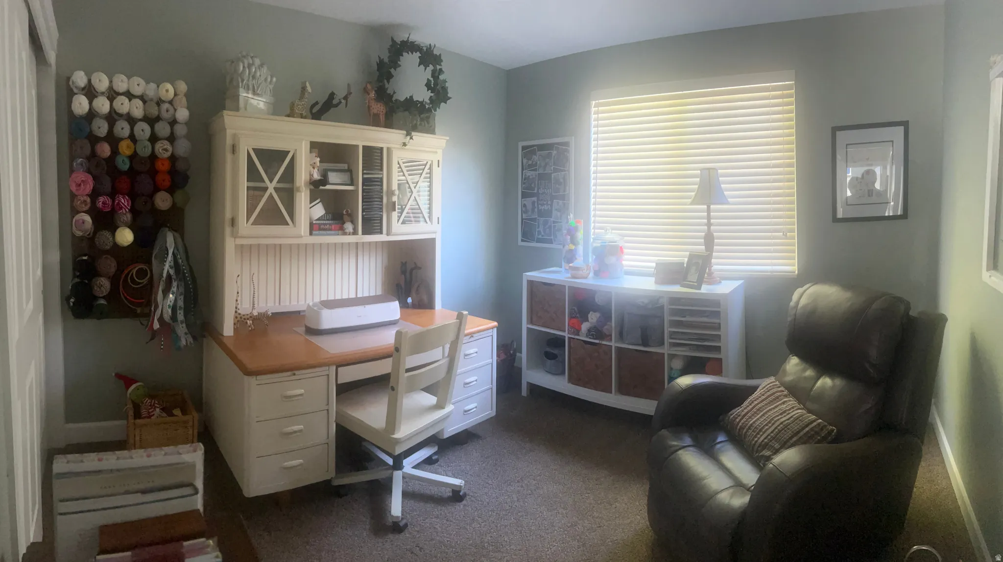 Wall-to-wall carpeting and a window with horizontal blinds