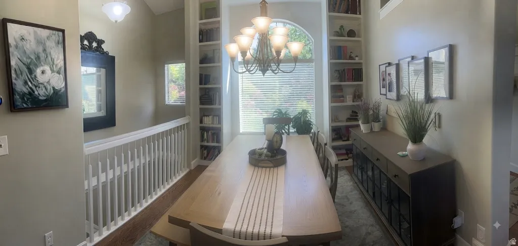 Arch-top window with blinds, flanked by built-in shelving