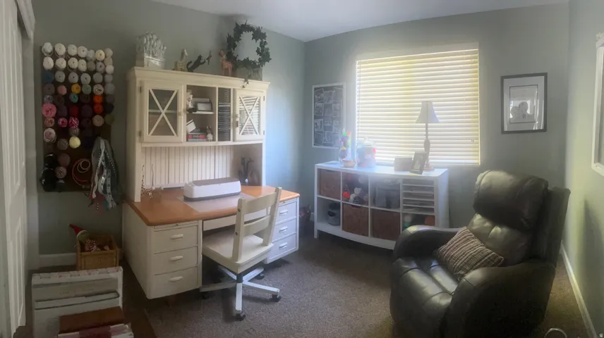 Wall-to-wall carpeting and a window with horizontal blinds