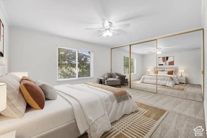 Expansive room featuring wall-to-wall carpeting and a white ceiling fan