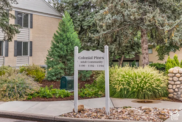 Established landscaping with mature trees, diverse shrubs, and ornamental grasses