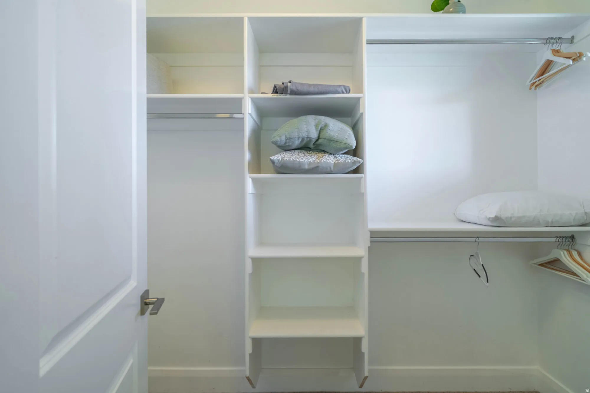 White closet system featuring built-in shelving and hanging rods