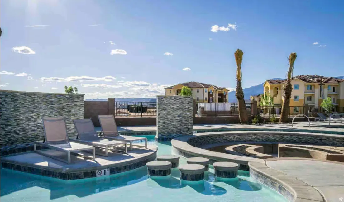 Swimming pool featuring integrated lounge seating and decorative tile accents